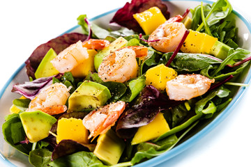 Salad with shrimps on white background