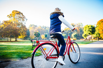 Urban biking - woman riding bike in city park