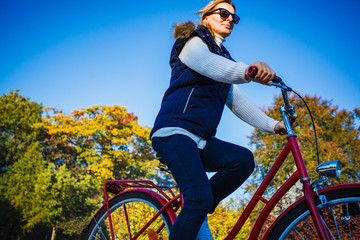 Urban biking - woman riding bike in city park