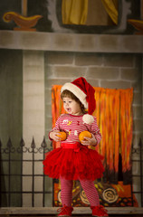 Beautiful little girl in red dress in vintage style