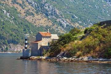 Fototapeta na wymiar Beautiful Mediterranean landscape. Montenegro, Adriatic Sea, Bay of Kotor. View of Church of Our Lady of Angels on sunny autumn day
