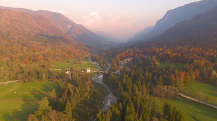 DRONE: Flying above river as it flows through the fall colored countryside.