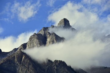 Clouds partially obscuring peak of cascade mountain in Banff national park, Canada.