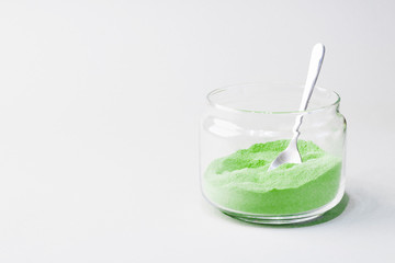 Green tea matcha in a glass jar. Matcha ginger latte. Rich source of antioxidants and polyphenols. Copy space for text