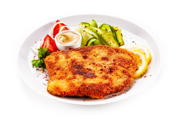 Fried pork chop and vegetable salad on white background