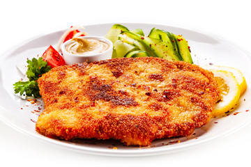 Fried pork chop and vegetable salad on white background