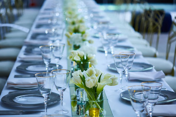 Elegance table set up with lotus flowers, selective focus.