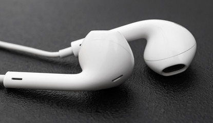 Small headphones on black background. Close up.