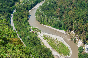 Fototapeta na wymiar mountain fast bubbling river between the rocks, river flow, top view