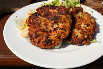traditional tirolean flat bread dumplings kaspressknödel filled with mountain cheese served with green salad Tirol alm