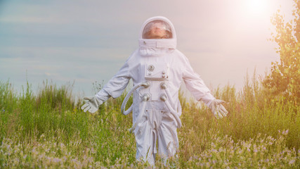 Astronaut returned to earth on the background of nature