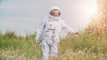 Astronaut returned to earth on the background of nature