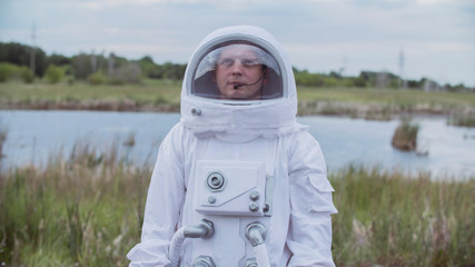 Astronaut returned to earth on the background of nature