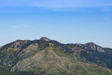 Fototapeta na wymiar Mountain peaks against the blue sky