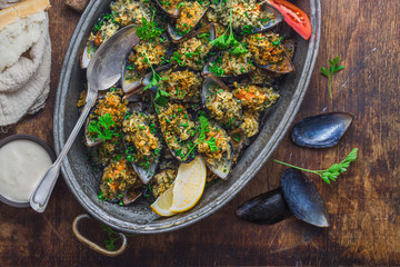 Yummy baked mussels under cheese and lemon, copy space