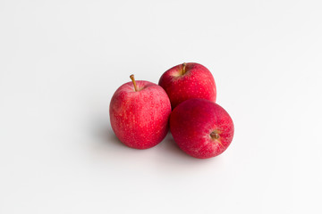Three fresh gala apples centered and isolated on a white background.