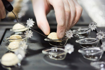 Chef is decorating delicious dish, motion blur on hands