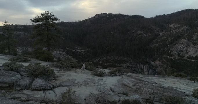 Drone paralel flight with running man in Yosemite National Park, 4k
