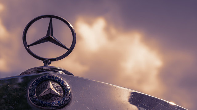 BERLIN, GERMANY - MAY 19, 2019: Classic Mercedes Logo And Star On A Mercedes Vintage Car Against A Cloudy Sky