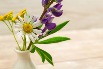 A small vase with flowers. Mother's Day Holidays Concept. Valentine's Day.