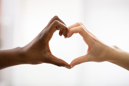 Multiracial Female Friend's Hands Showing Heart Shape