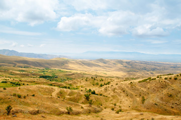 Beautiful summer landscape. Steppe. The mountains. The sky with clouds.