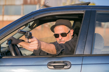 mobster in car perpetrating a crime