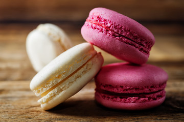 Multicoloured macarons on a dark wood background