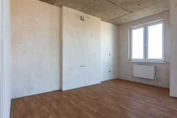 Fragment of an interior in a new building, a room with a fine finish and a window