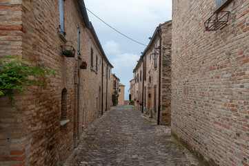 Fototapeta na wymiar Gates and walls of medieval fortress in Montegridolfo near Rimini, Italy.