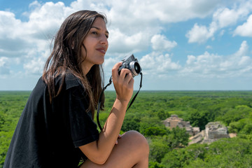 Traveler woman taking photos of Ek Balam ruins in Yucatan, Mexico