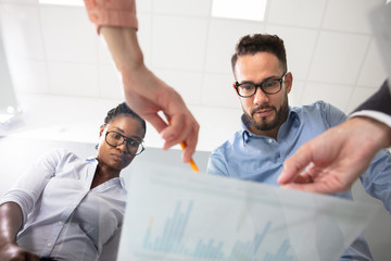 Diverse Executive Discussing The Business Projects On Desk