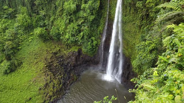 Fuipisia Waterfall in Samoa amongst the lush green landscape, Panning from left to right