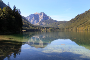 Fototapeta na wymiar Scenic view of the great landscape reflecting on the shallow crystal clear water of the Vorderer Langbathsee near Ebensee, Oberösterreich, Austria