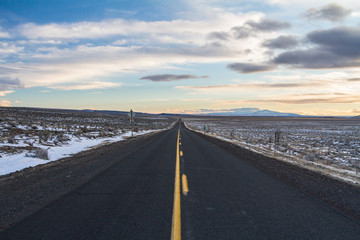 Straight road ahead with vibrant sunset sky