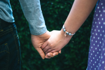 Girl with young man's hand