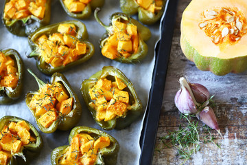 Paprika peppers stuffed with pumpkin. Baked paprika with pumpkin. Vegan lunch. Autumn food. Selective focus. Macro.