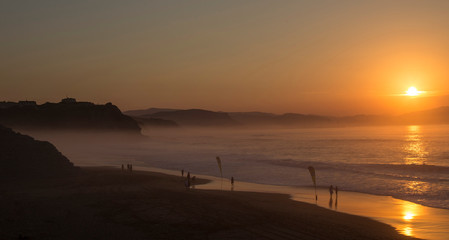 beautiful sunset in long beach with people walking along the shore, Sopelana, Spain © Patrick