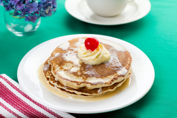 Delicious tres leches pancakes with cherry on top