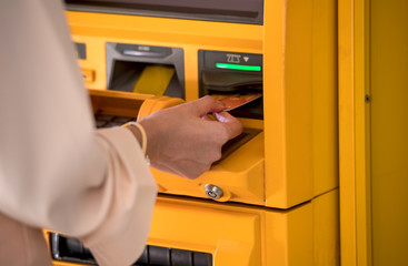 Hand of Business women using credit cards to withdraw money from ATMs