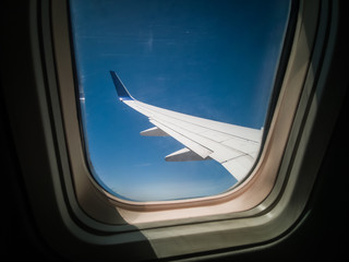 airplane wing sky through the window