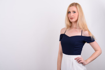 Young beautiful British woman with blond hair against white background