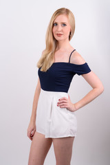 Naklejka premium Young beautiful British woman with blond hair against white background