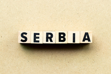 Letter block in word Serbia on wood background