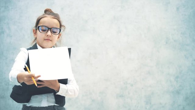 Smiling and happy brunette Caucasian small business girl. With a black folder standing in a white shirt, isolated over a white background. In the hair pencil.