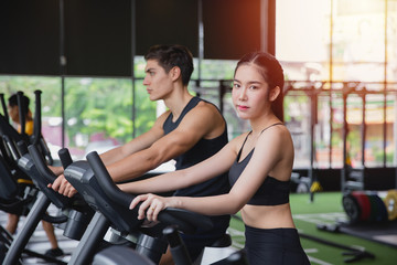 Healthy woman and man with sportswear running training on exercise at gym sport, bodybuilding, lifestyle and people concept