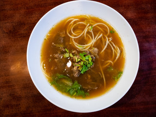 Braised beef Spaghetti soup on wood table