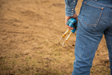 Cowboy preparing to vaccinate calves on the ranch