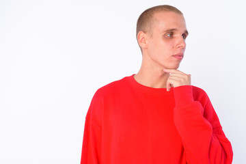 Face of young bald man thinking while looking away