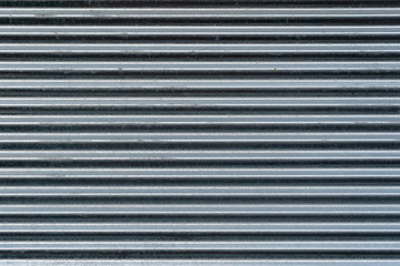 Obraz premium Metal wall texture, background. Sheet of ribbed galvanized metal for building structures. It is used for covering roofs for construction of fences